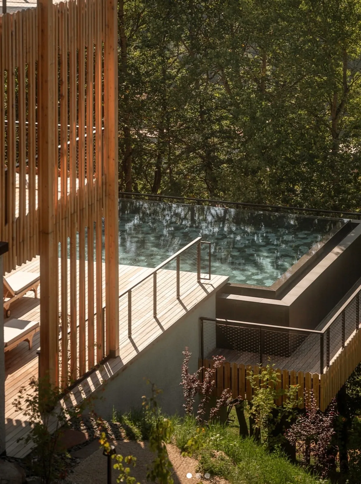 Infinity pool surrounded by forest at ENGEL AYURPURA